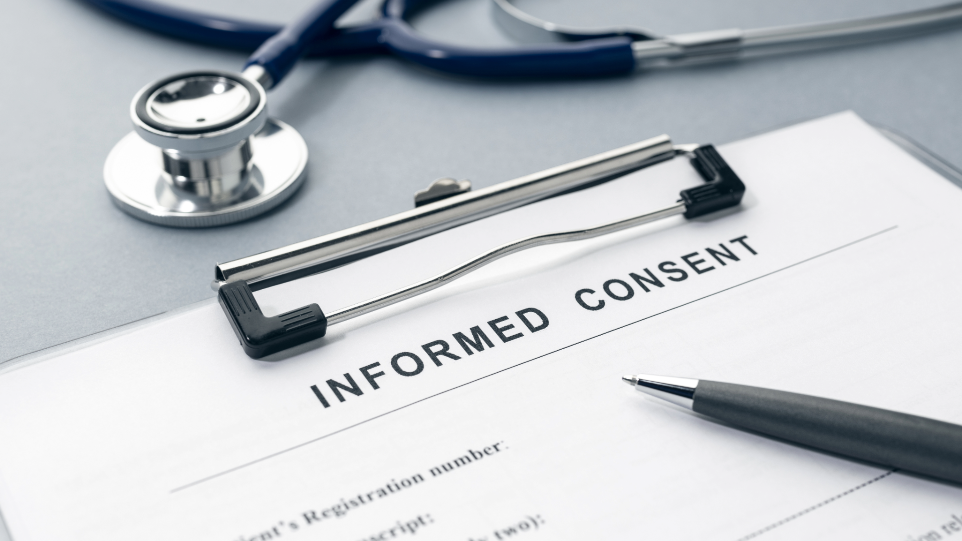 Document entitled informed consent on a clipboard with a pen