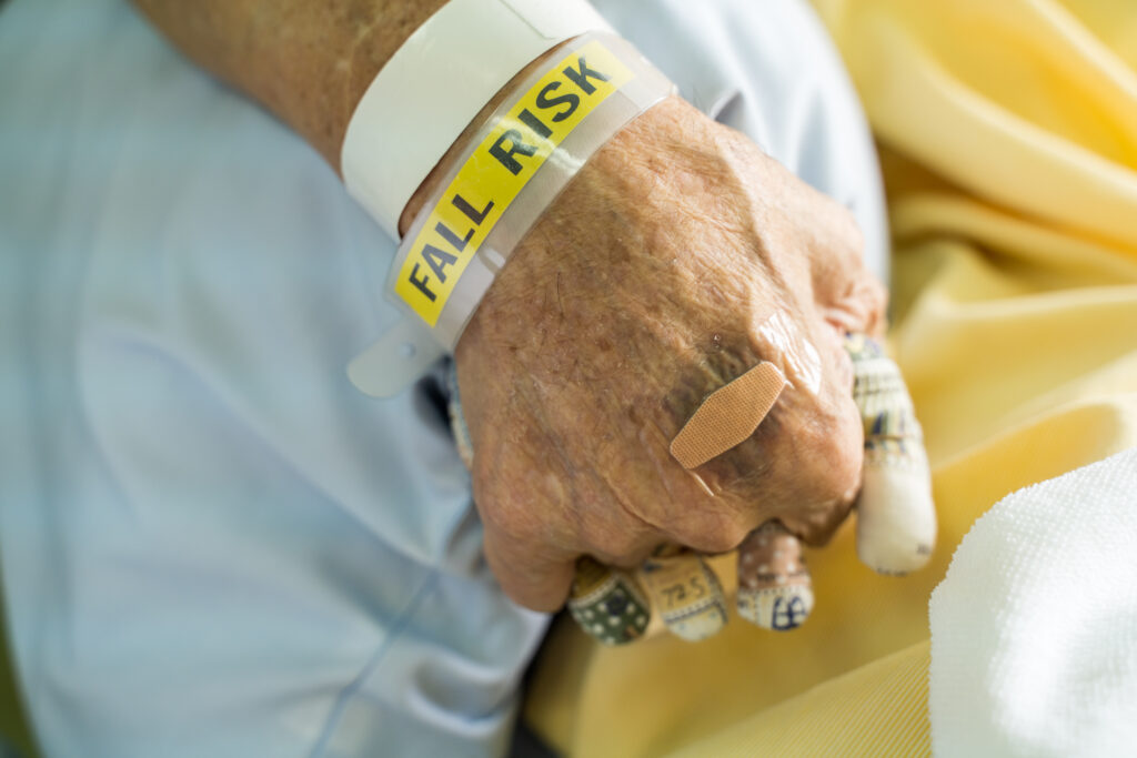 Hospital Falls in Ontario: When Negligence Causes Serious Injury | Paul Cahill Medical Malpractice Lawyer An elderly hospital patient wearing a yellow falls risk identification bracelet
