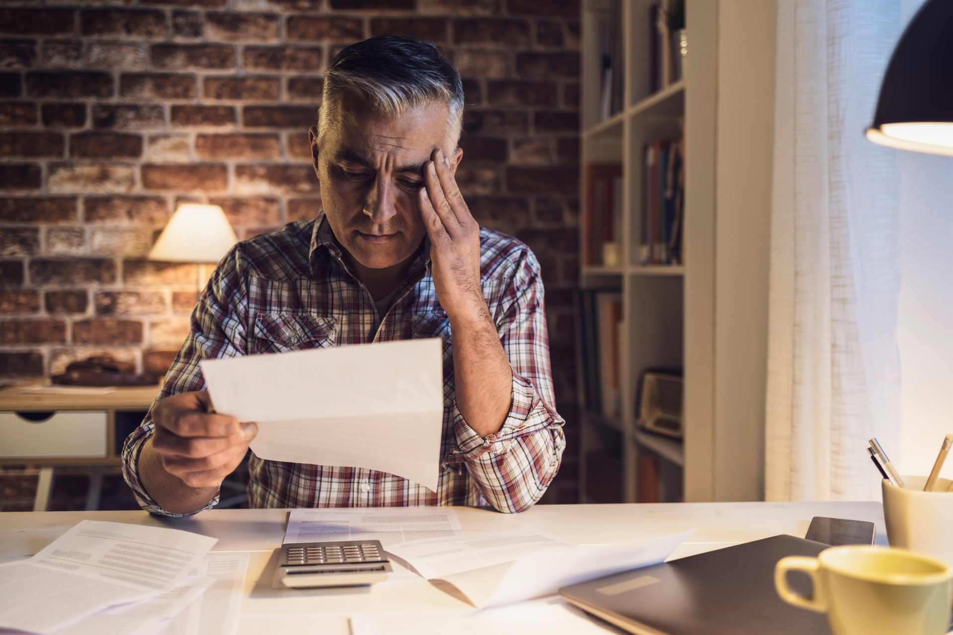 A man looking at medical bills