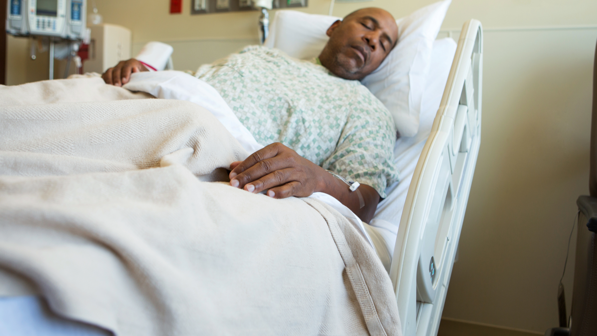 A man lying in a hospital bed.