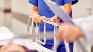 Patient on Stretcher in Hospital Emergency Room | Paul Cahill Medical Malpractice Lawyer Nurse and physician attending to a patient on a stretcher in a hospital emergency department, illustrating hallway medicine in Ontario.